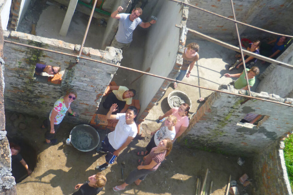Gruppe internationaler Volunteers bei einem Bauprojekt in Nepal, Blick von oben