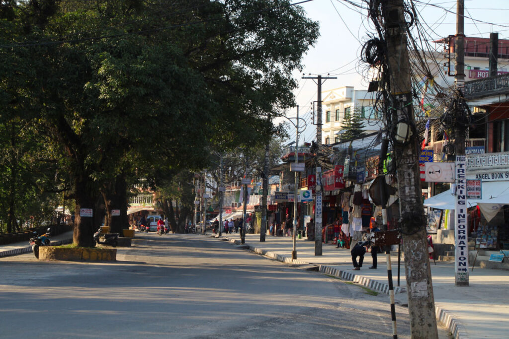 Straße im Viertel Lakeside in Pokhara mit Geschäften und Stromleitungen