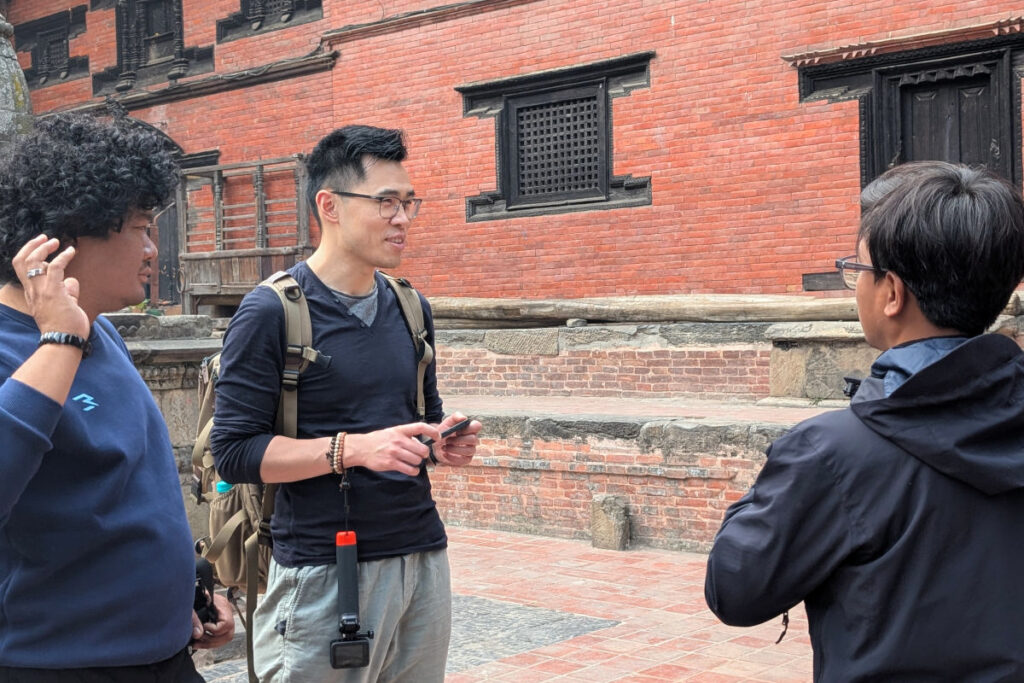 Gespräch mit lokalen Partnern vor einem historischen Gebäude in Kathmandu.